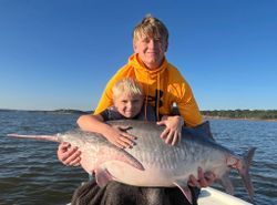 Two people fishing on the beach in Sand Springs