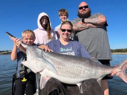 Group of 6 people fishing on sandy beach in Sand Springs