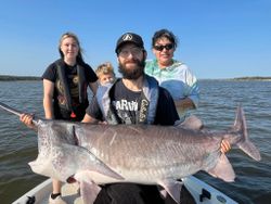 Four people fishing on the beach in Sand Springs