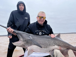 Two people enjoying a day of fishing on the sand in Sand Springs