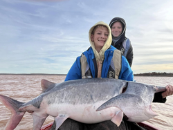 Anglers with a big fish during an OK fishing trip