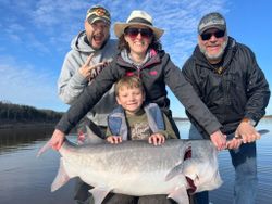 Four people fishing at the beach in Sand Springs