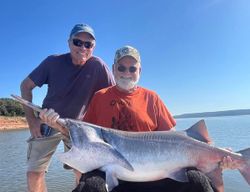 Two people fishing on the sand in Sand Springs