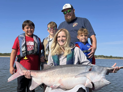 A group of 5 people fishing on the beach in Sand Springs