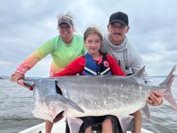 Three people fishing on the sand in Sand Springs