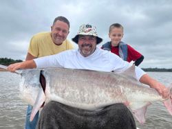 Three people fishing on sand beach in Sand Springs