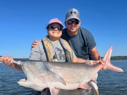 Two people fishing on the beach in Sand Springs