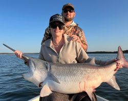 Two people fishing on the sand in Sand Springs