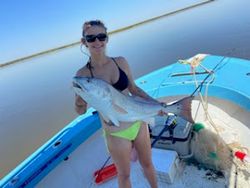 A lone fisherman reeling in a big catch in GA