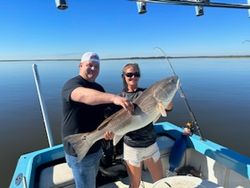 Two anglers fishing in Darien with a single catch