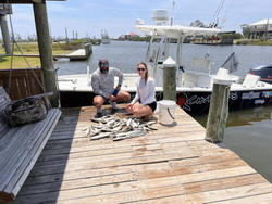Two anglers fishing in the scenic bay at Bay St. Louis