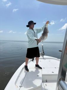 A fisherman with a 18-inch catch at Bay St. Louis