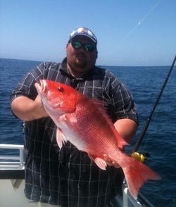 Angler reeling in a 20-inch fish at Fernandina Beach