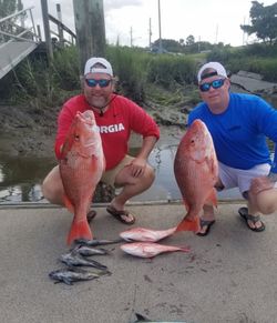 Two anglers with a great catch of two fish in Fernandina Beach