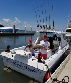 2 people fishing for a single large fish in FL