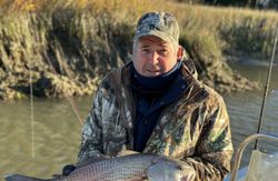Angler holding caught redfish on boat in Darien GA waters