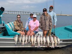 Successful redfish and black drum fishing trip in Rockport TX with multiple fish displayed on boat deck
