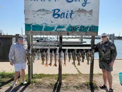 Fishing charter display showing multiple redfish catch hanging on rack in Rockport TX marina