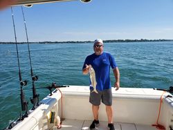 One person fishing at the lakeside in Marblehead