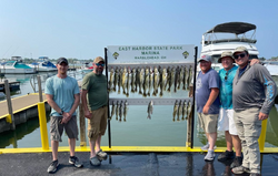 Five people fishing at the lakeside in Marblehead