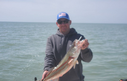 A person fishing on the lakeside in Marblehead