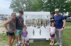 Six people fishing at lakeside in Marblehead