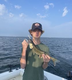 A person fishing by a lakeside in Lakeside Marblehead