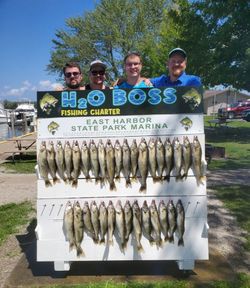 Four people fishing at the lakeside in Marblehead