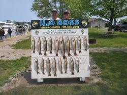Four people fishing with large catch of 10 fish at lakeside in Marblehead