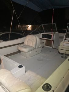 Interior view of boat cabin with captain's chair and white fiberglass surfaces at Lake Park FL