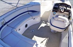 White speedboat interior with blue and white seating, steering wheel and control panel in Lake Park FL