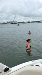 Swimming in harbor waters near marina with boats and sailboats in Lake Park FL