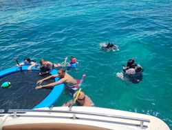 Tour group snorkeling in clear blue waters near Lake Park FL with floating equipment