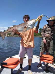 Two people fishing with a large fish in FL