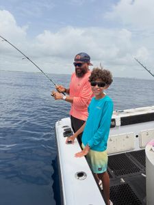 Fishing from boat deck in Lantana FL waters with fishing rods extended