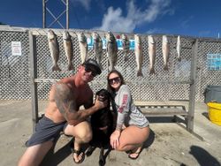 Successful fishing trip in Corpus Christi TX showing redfish, black drum, and speckled trout catch displayed on cleaning station