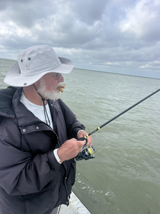 Casting lines into the deep blue under scattered clouds in Port Mansfield!