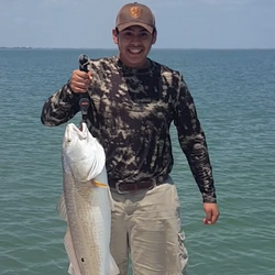 Angler with 18-inch catch in Port Mansfield