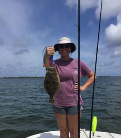 An angler fishing for a summer flounder in Florida