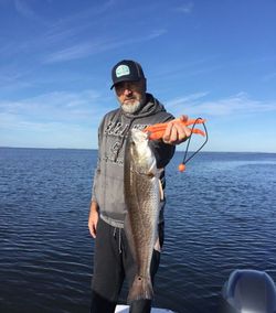 A person fishing for a redfish in Florida