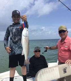 A group of 3 people fishing for redfish in Florida