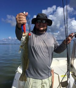 A person fishing for a spotted weakfish in Florida
