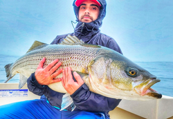 A person fishing with a rod in NY