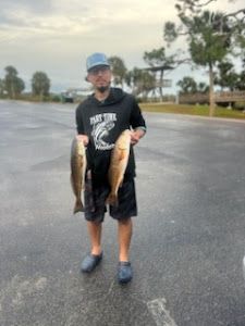 2 fishing rods with person on the bank of a river in Fritch