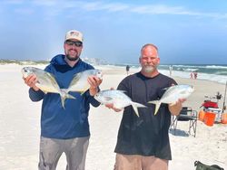 Two people with a catch of three Florida Pompano and Permit fish in Pensacola