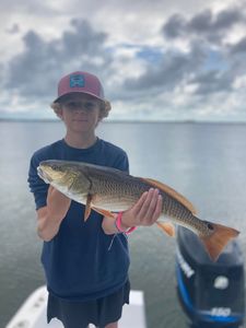 A fisherman with a large redfish caught in Panama City Beach, Florida