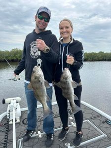 Two anglers fishing with black drum fish in Hudson