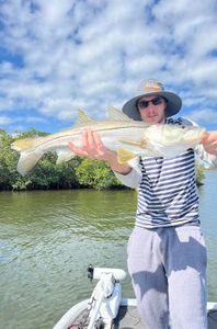 A person fishing for a snook in FL