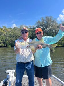 A snook caught by two people fishing in Hudson