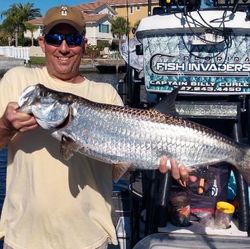 Angler with a large tarpon fish catch in FL